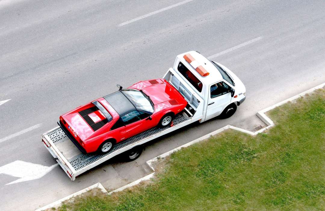 Atm Towing Services Securing A Vehicle On A Flatbed For Transport